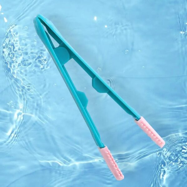 Green Pink tipped tweezer eye goop remover floating on water